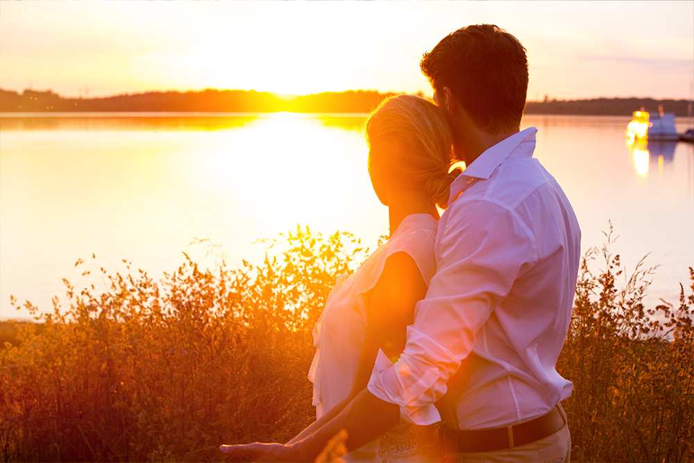 Couple enjoying a romantic sunset by the lake during a short vacation
